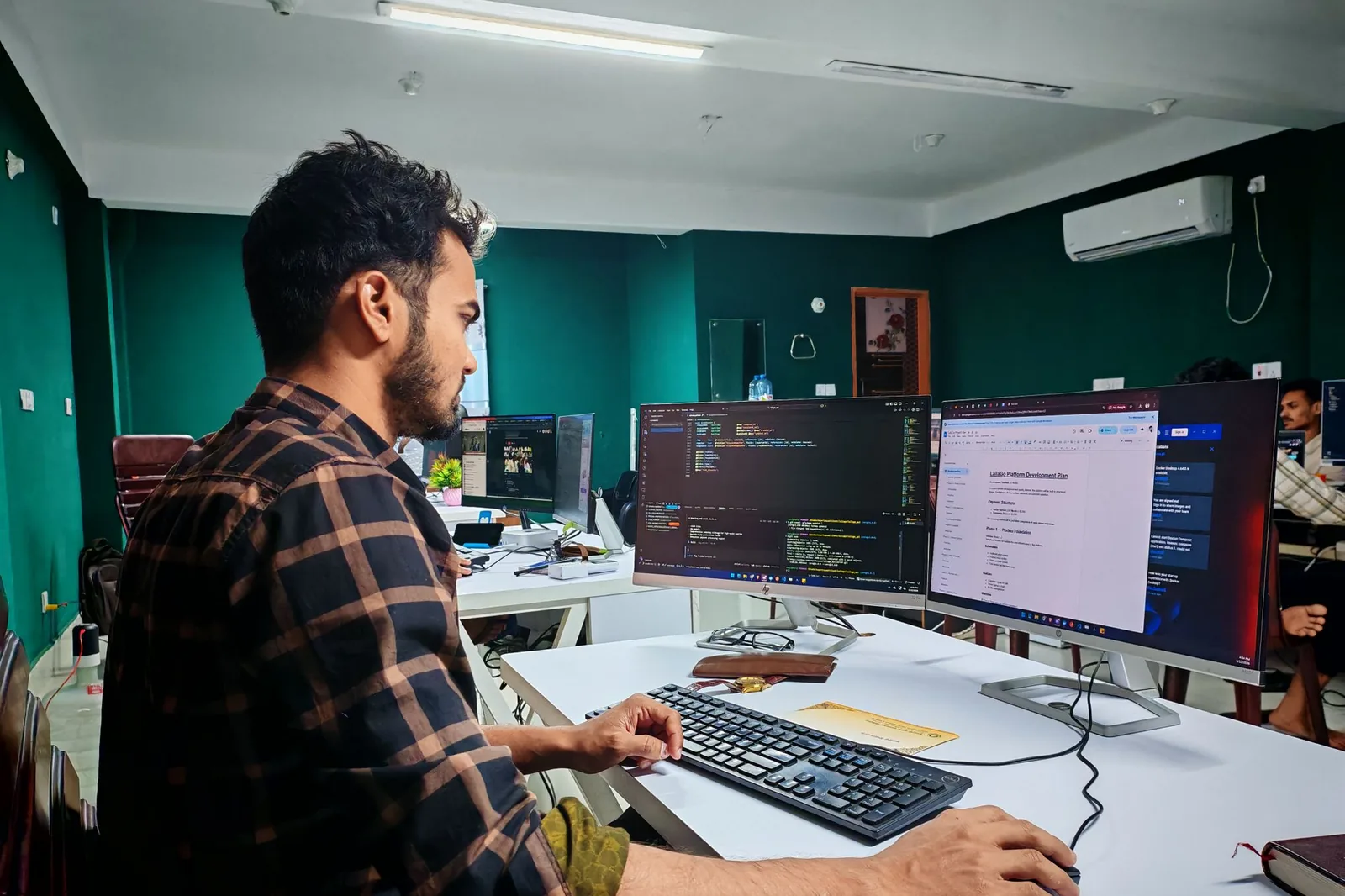 Network Doctor IT support engineer working across dual monitors at the managed IT services desk